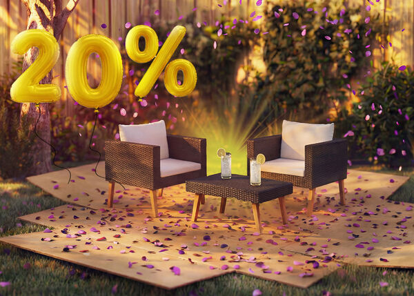 Outdoor rattan lounge chairs with cushions and a small table in a garden setting, decorated with pink confetti and golden 20% discount balloons, highlighting seasonal deals on garden lounge furniture.
