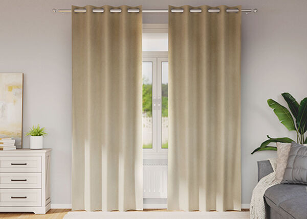 Beige curtains filtering sunlight in a cosy room.