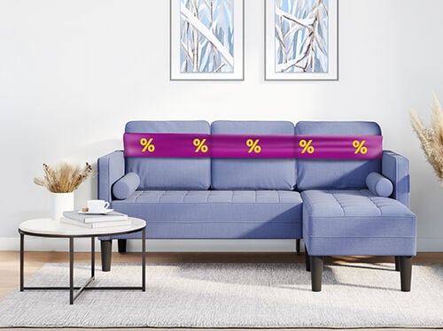 Grey two-seater sofa with purple ribbon showing discount icons, in a styled living room. Click to see the products in the offer.