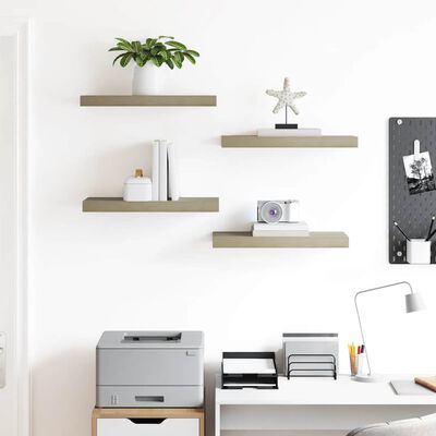 White wall with floating wooden shelves holding books and decor, desk below