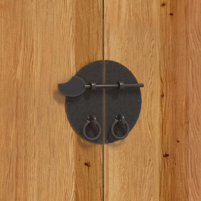 Close-up of black circular door handles on wooden cabinet.