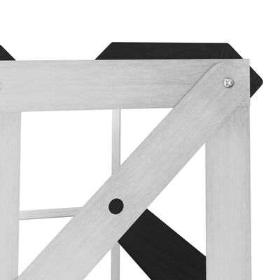 Corner of a wine rack showing wooden or metal frame joints and black shelf slats.