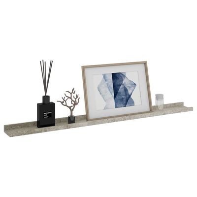 Long gray concrete-like shelf with decorative items including frame and diffuser.