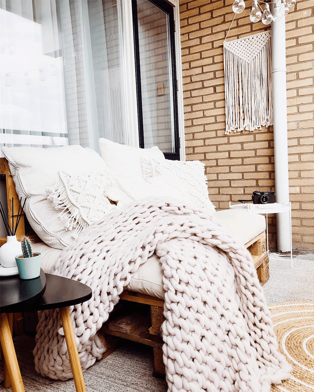 a pallet couch and a big, fluffy blanket