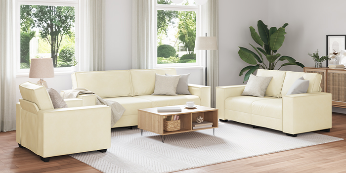 Indoor living room set with metal-frame sofas, armchair, coffee table, and white rug. Click to shop the collection.