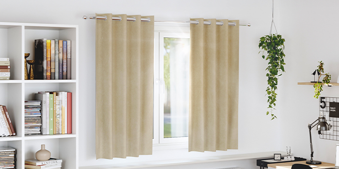 Beige curtains filtering light in a home office. Click to shop the collection.